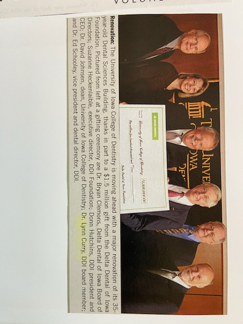 A newspaper clipping of Dr. Lynn Curry and the Delta Dental board members holding a check for 1,500,000.00