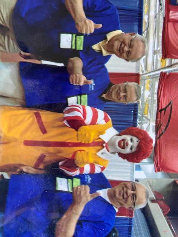 Dr. Lynn Curry gives a thumbs up in a photo with Ronald McDonald and two other Delta Dental workers. 