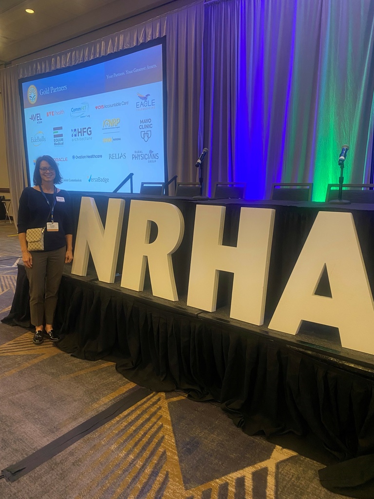 Jen Jones posing with the NRHA conference sign 